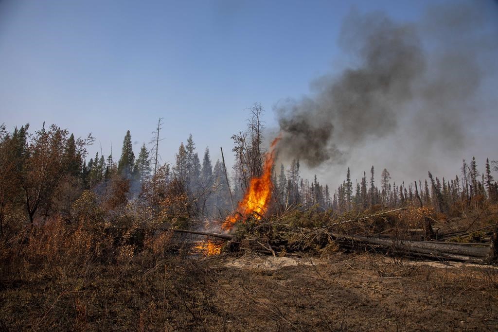 Small spot fires continued to flare up alongside Northwest Territories highways leading into Hay River, Fort Smith and Yellowknife, Friday, Sept. 15, 2023.