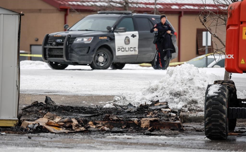 Police investigate the scene after fire officials say three people died after an early morning fire in a garden shed outside a home improvement store in Calgary, Monday, Dec. 11, 2023. THE CANADIAN PRESS/Jeff McIntosh.