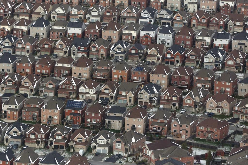 A Markham, Ont.,-based developer has been ordered to pay almost $185,000 in fines and restitution for after pleading guilty at an Ontario court to illegally selling new homes. An aerial view of houses east of Toronto is shown on Saturday, Nov. 11, 2017.