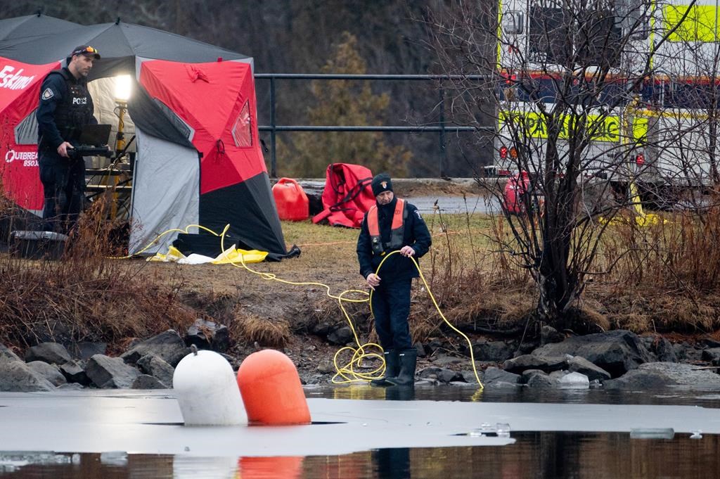 Members of the Ottawa Police Service Underwater Search and Recovery Unit conduct an underwater search on Thursday, Dec. 28, 2023. A spokeswoman for an Ottawa school board says its community is feeling the tragedy deeply after local police confirmed the deaths of two teens who fell through ice on the Rideau River in the city’s south end.