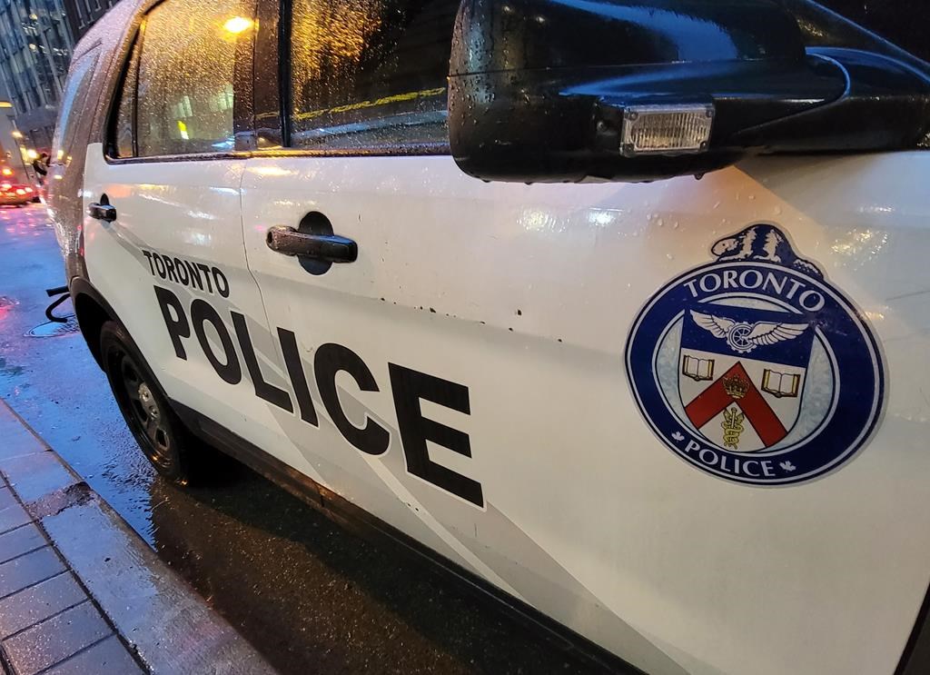 A Toronto police vehicle is shown parked on Yonge Street as rain falls in downtown Toronto on Tuesday Jan. 3, 2023. THE CANADIAN PRESS/Doug Ives.