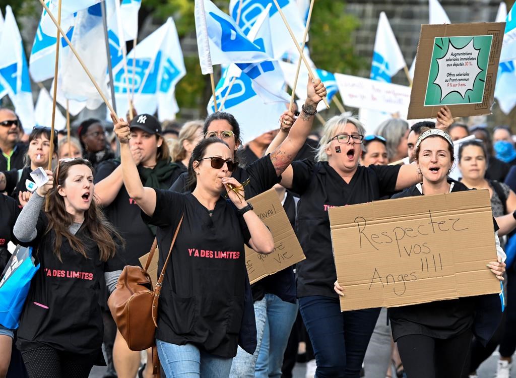 Members of the Fédération Interprofessionnelle de la santé du Quebec union march to the National Assembly in Quebec City on Oct. 2, 2023. The union announced a tentative agreement with the provincial government Tuesday.