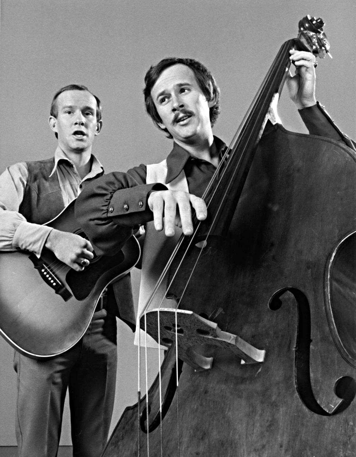 A still from the 'Smothers Brothers Comedy Hour' showing Tom and Dick Smothers playing the guitar and bass.