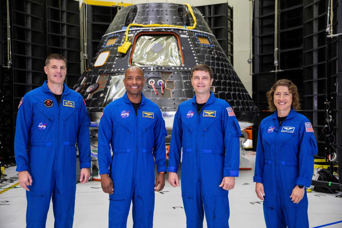 Artemis II crew members, from left, Jeremy Hansen, Victor Glover, Reid Wiseman and Christina Koch, stand together at NASA’s Kennedy Space Center in Florida, in front of an Orion crew module on Tuesday, Aug. 8, 2023. The U.S.-Canadian crew inspected the capsule during a visit late Monday and Tuesday. NASA plans to send the four around the moon and back late next year. (Kim Shiflett/NASA via AP)