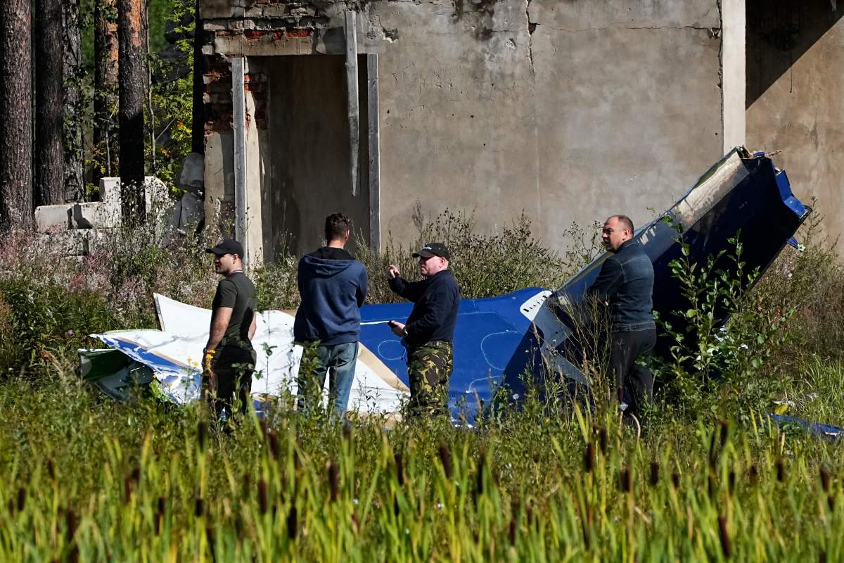 Russian investigators inspect a part of a crashed private jet near the village of Kuzhenkino, Tver region, Russia, Thursday, Aug. 24, 2023. Russia’s mercenary chief Yevgeny Prigozhin’s presumed death in a plane crash along with some of his top lieutenants raised questions about the future of his Wagner Group that has sent forces to African countries. (AP Photo/Alexander Zemlianichenko, File)