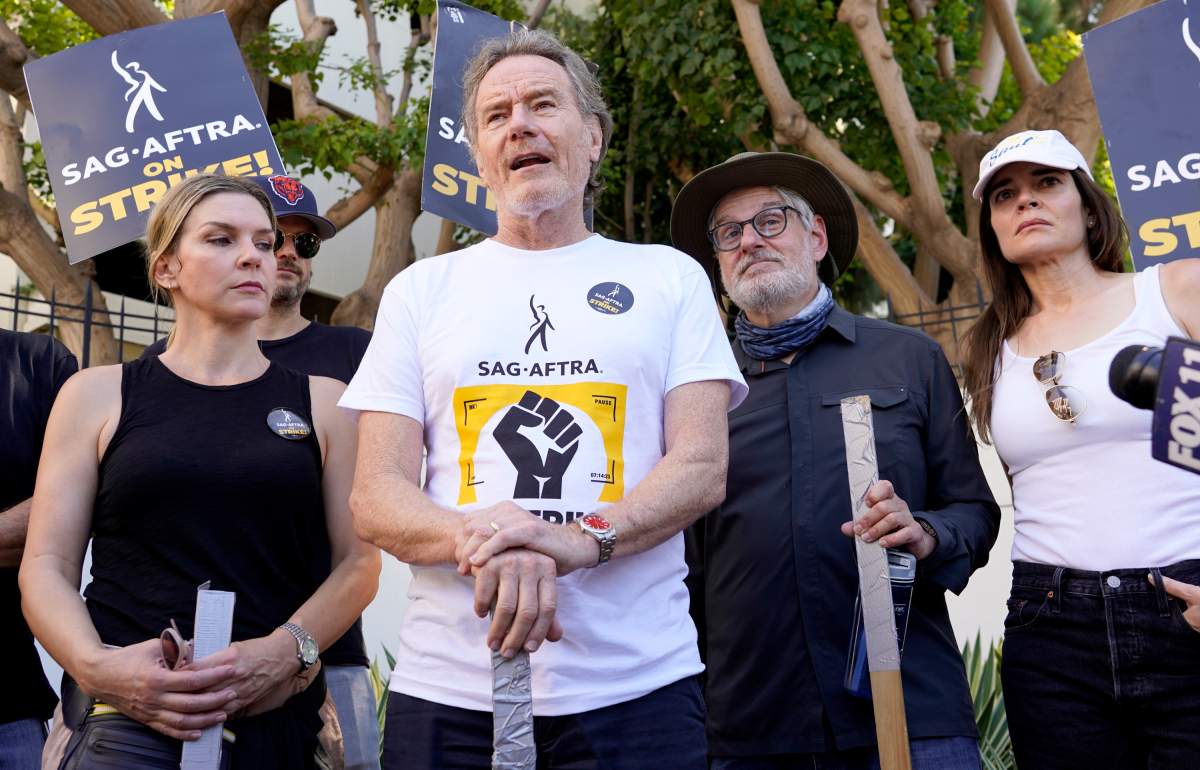 Rhea Seehorn, from left, Bryan Cranston, writer Peter Gould and Betsy Brandt, from the acting and writing team of “Breaking Bad,” speak on a picket line outside Sony Pictures studios on Tuesday, Aug. 29, 2023, in Culver City, Calif. The film and television industries remain paralyzed by Hollywood’s dual actors and screenwriters strikes. (AP Photo/Chris Pizzello)