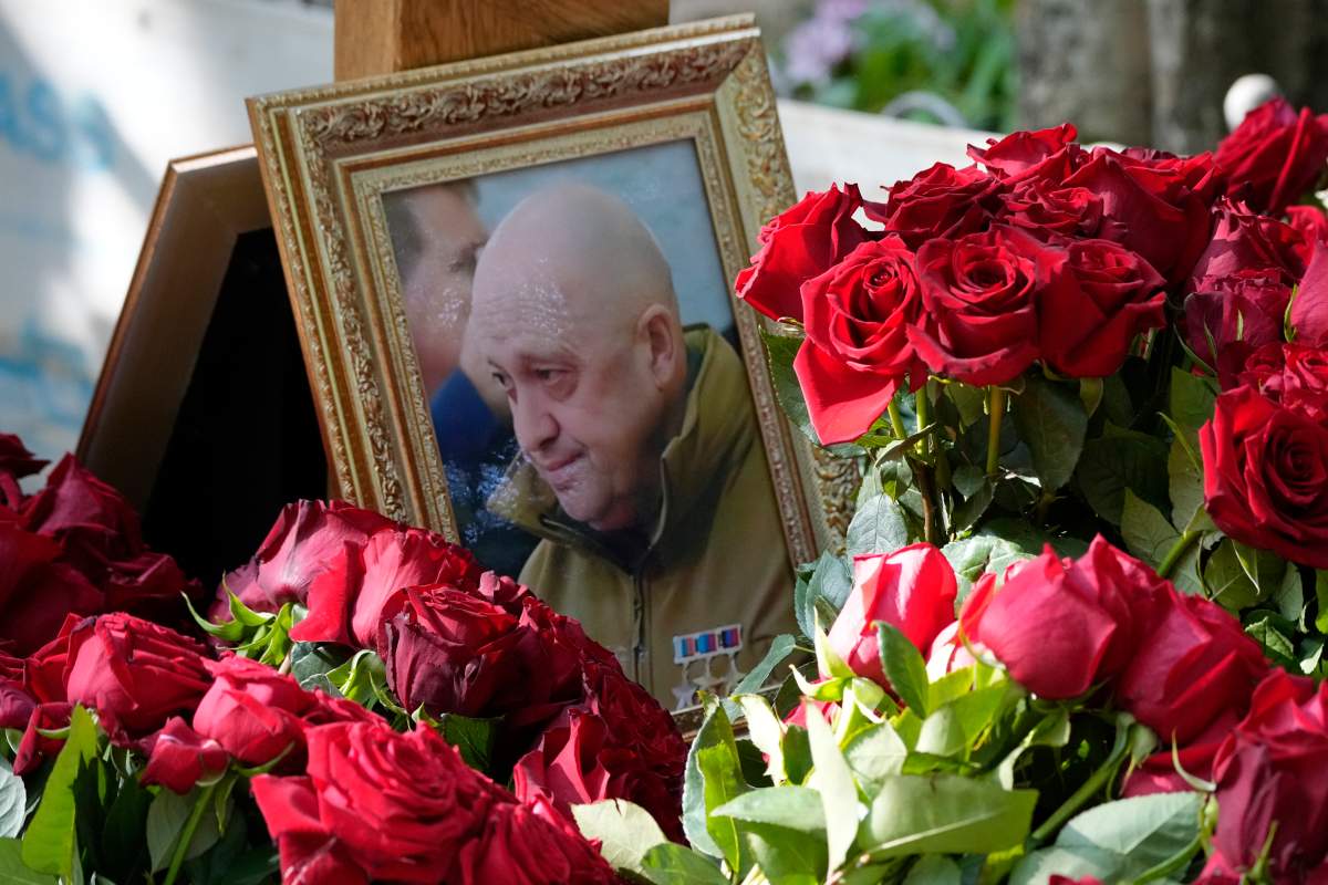 A portrait of Wagner Group’s chief Yevgeny Prigozhin, who died last week in a plane crash two months after launching his brief rebellion, lies on flowers on the grave at the Porokhovskoye cemetery in St. Petersburg, Russia, on Wednesday, Aug. 30, 2023. (AP Photo/Dmitri Lovetsky)