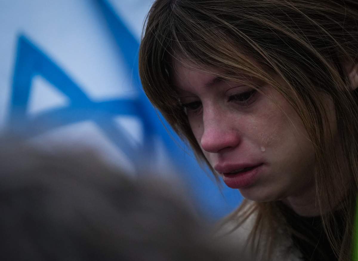 Tears stream down a woman’s face during a vigil organized by the Jewish Federation of Greater Vancouver in support of those killed in Israel by Hamas, in Vancouver, on Tuesday, October 10, 2023. THE CANADIAN PRESS/Darryl Dyck
