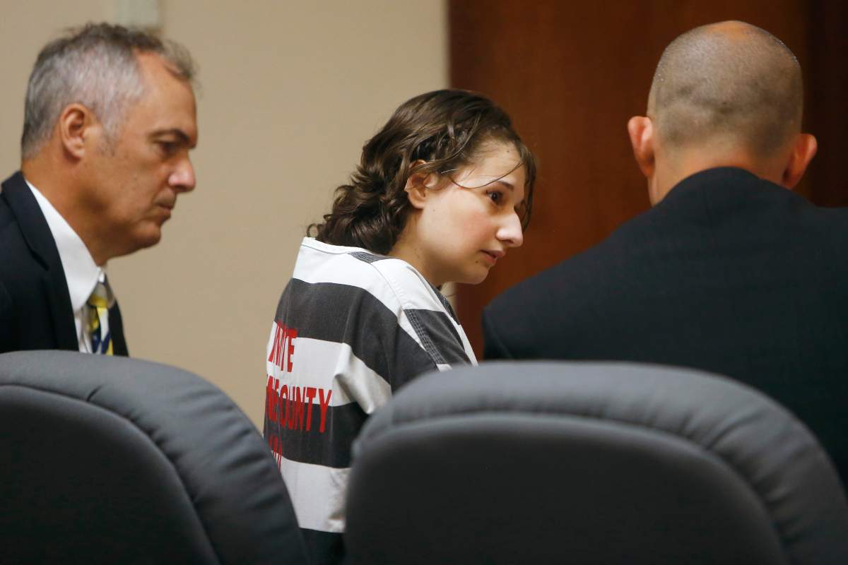 Gypsy Rose Blanchard speaks with her lawyer’s Mike Stanfield, right, and Clate Baker before her court appearance, July 5, 2016, in Springfield, Mo.