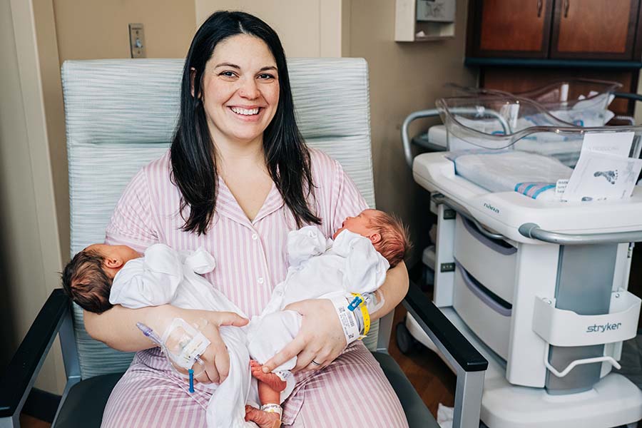 Kelsey Hatcher, 32, gave birth to twin girls after becoming pregnant in both her two uteruses. She is pictured holding baby Roxi on the left and baby Rebel on the right.