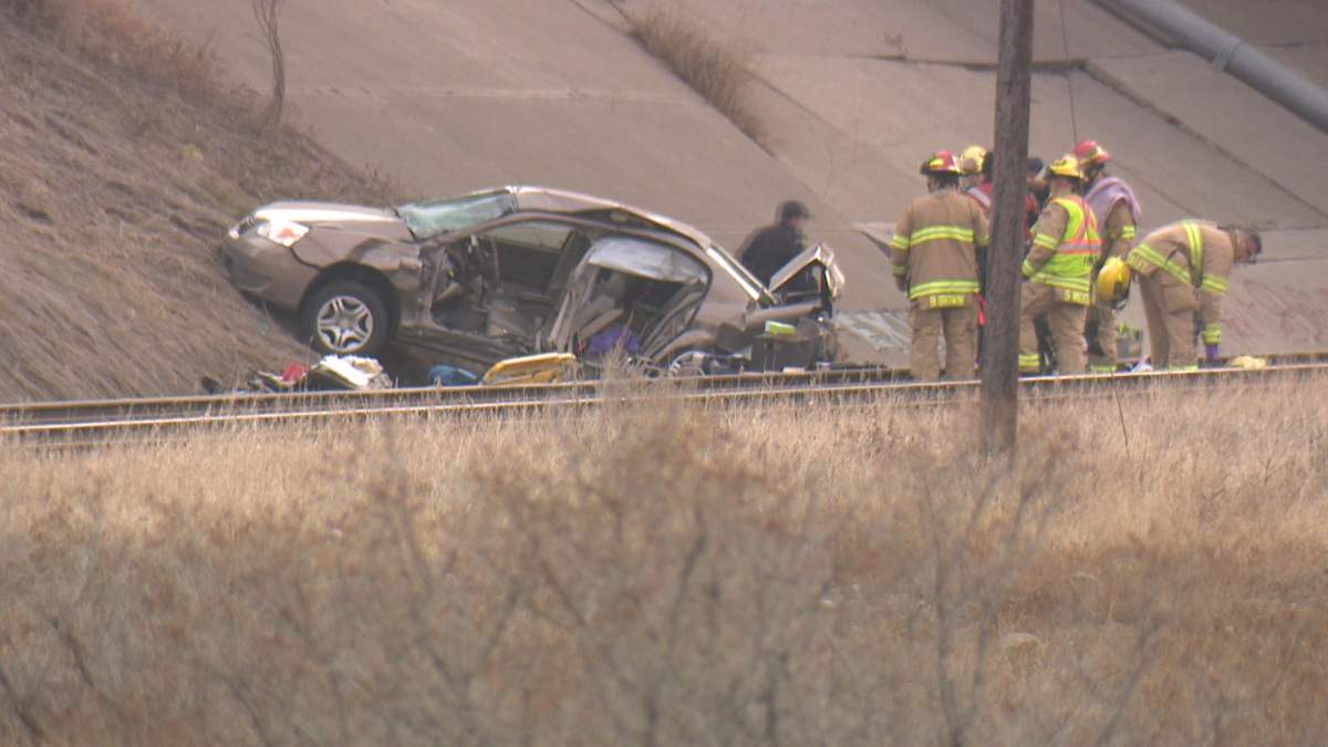 A sedan is seen at the bottom of an embankment in Calgary midday on Dec. 1, 2023.