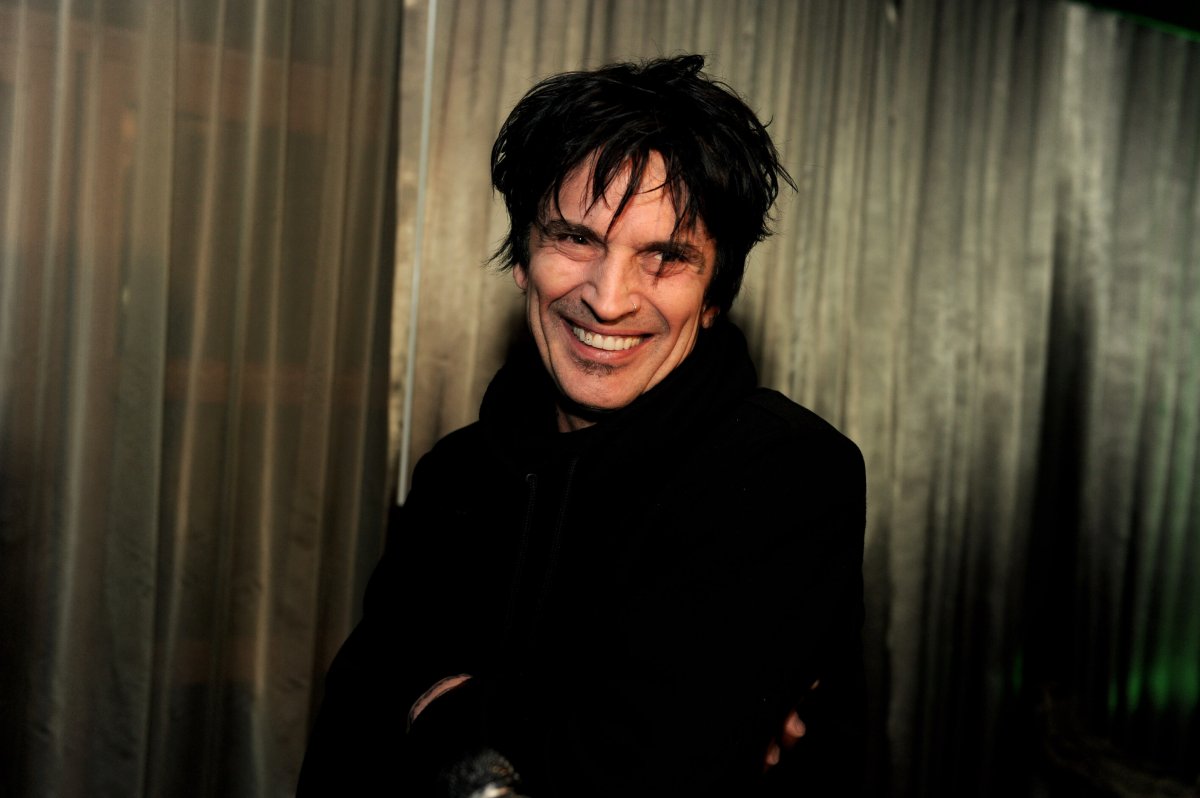 Tommy Lee smiling. He is wearing a black shirt.