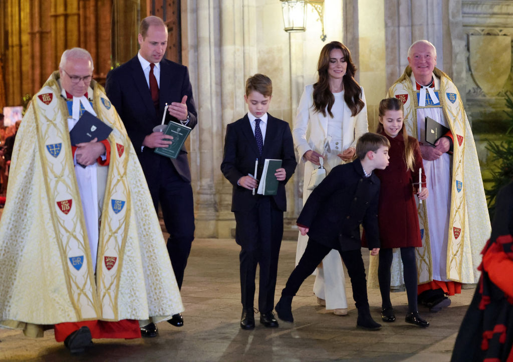 Britain's Princess Charlotte of Wales (2R) has her candle blown out by Britain's Prince Louis of Wales (3R) at the "Together At Christmas" Carol Service" at Westminster Abbey in London on December 8, 2023.