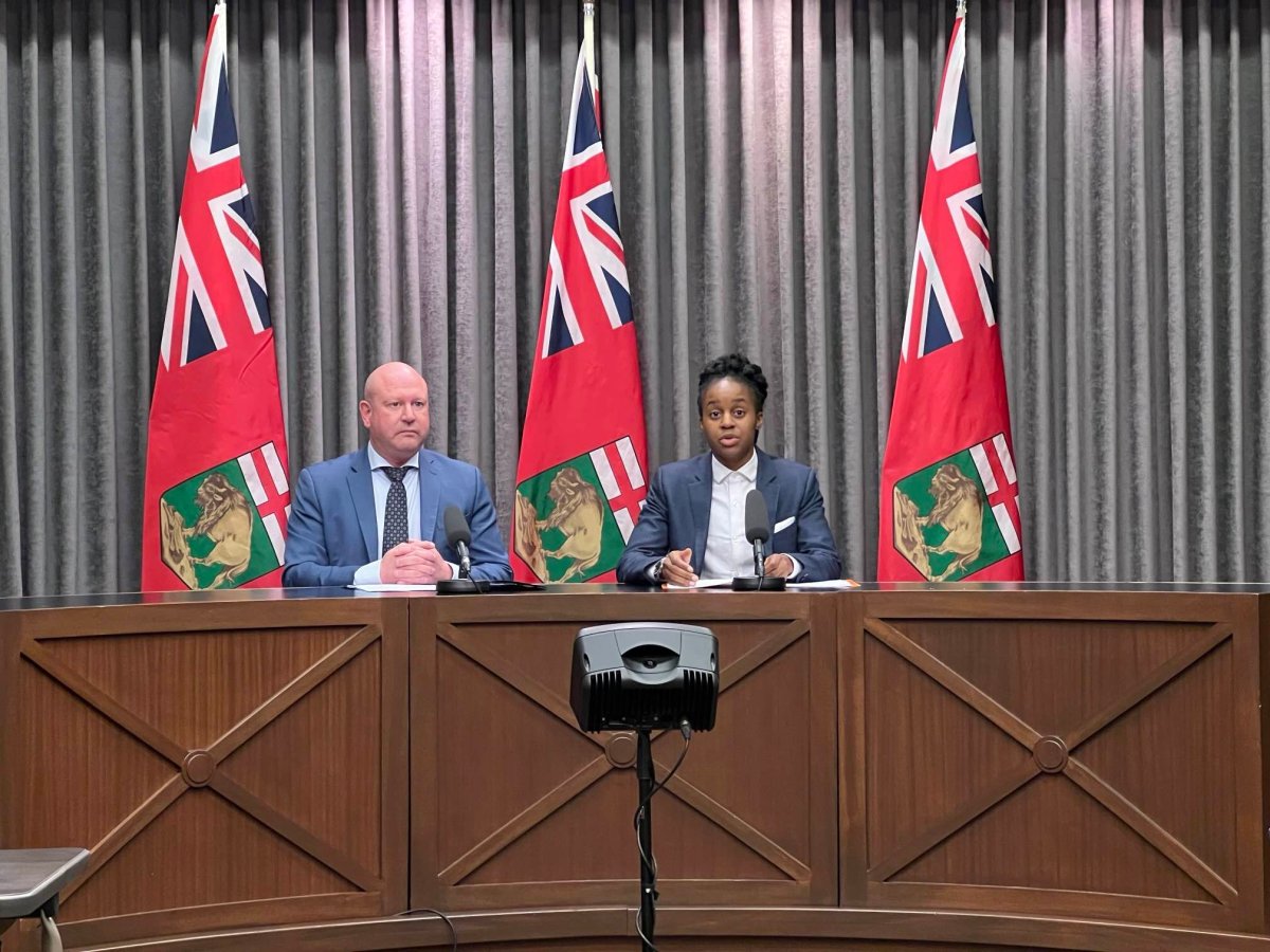 Manitoba Health Minister Uzoma Asagwara (right) at a press conference on Dec. 14, 2023, discussing the province's outlook on respiratory virus vaccines.