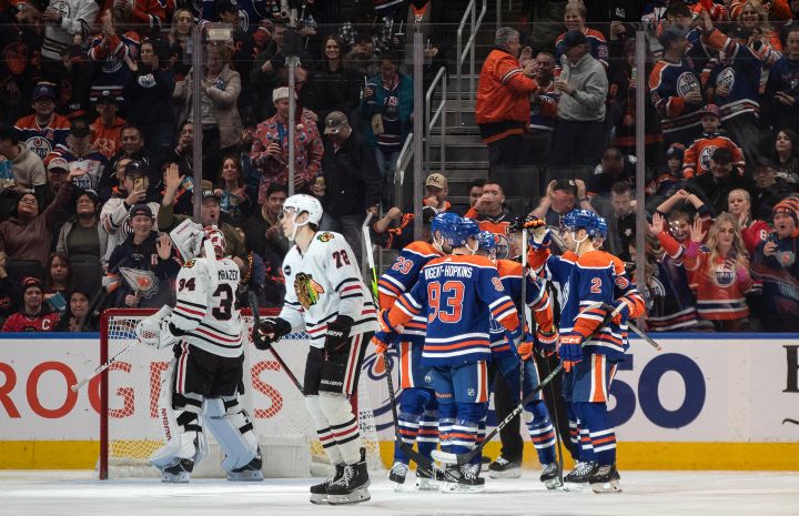 Chicago Blackhawks goalie Petr Mrazek (34) and Alex Vlasic (72) look on as the Edmonton Oilers celebrate a goal during third period NHL action in Edmonton on Tuesday December 12, 2023.