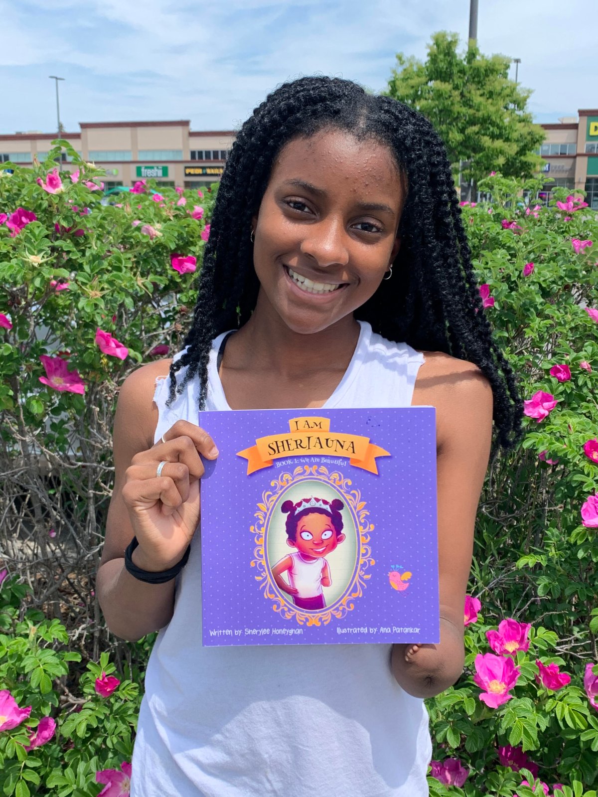 Sheriauna holding the book her mother wrote