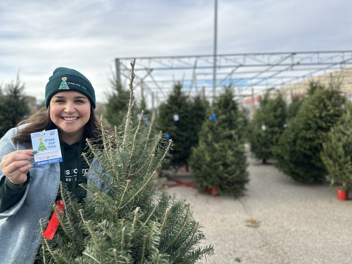Jodi Carreiro, community engagement manager at the Children’s Foundation, tags trees at Stone Road Canadian Tire tree lot.