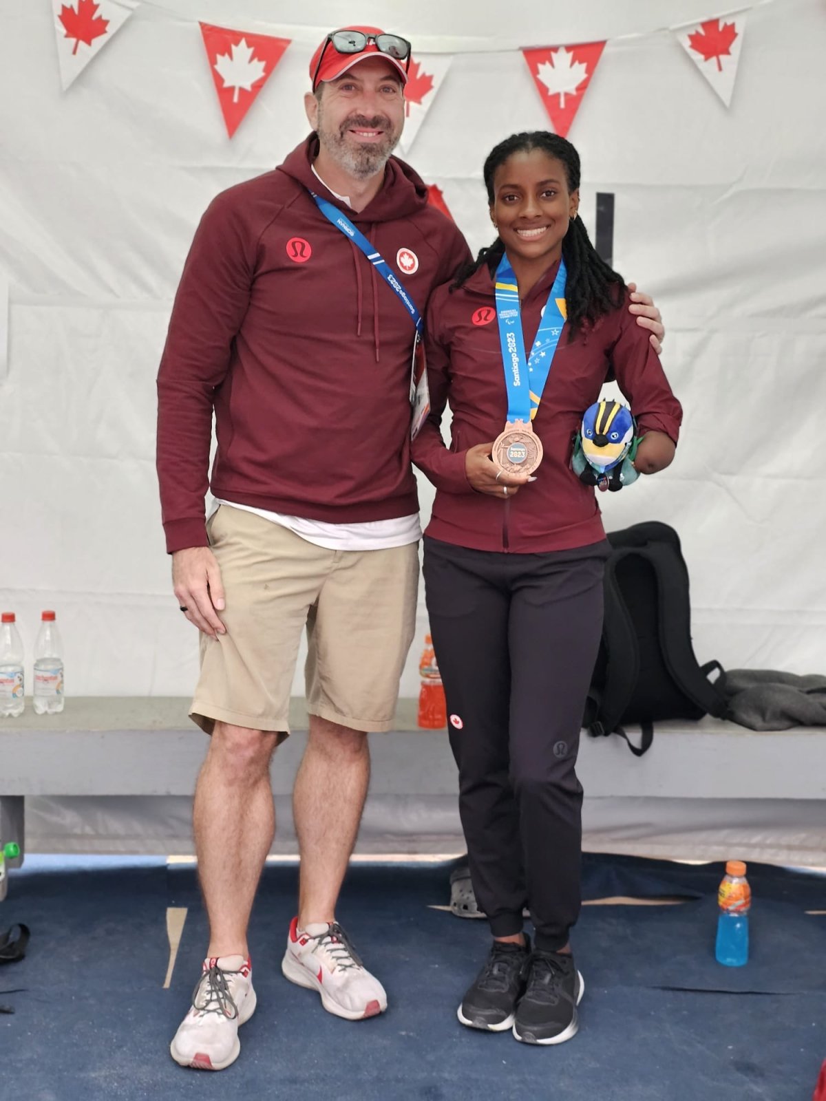 Coach Bob Westman (L) and Sheriauna (R) posing with her bronze medal