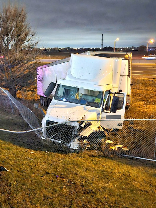 A transport truck collided with a vehicle after it stopped in a live lane on Highway 400.