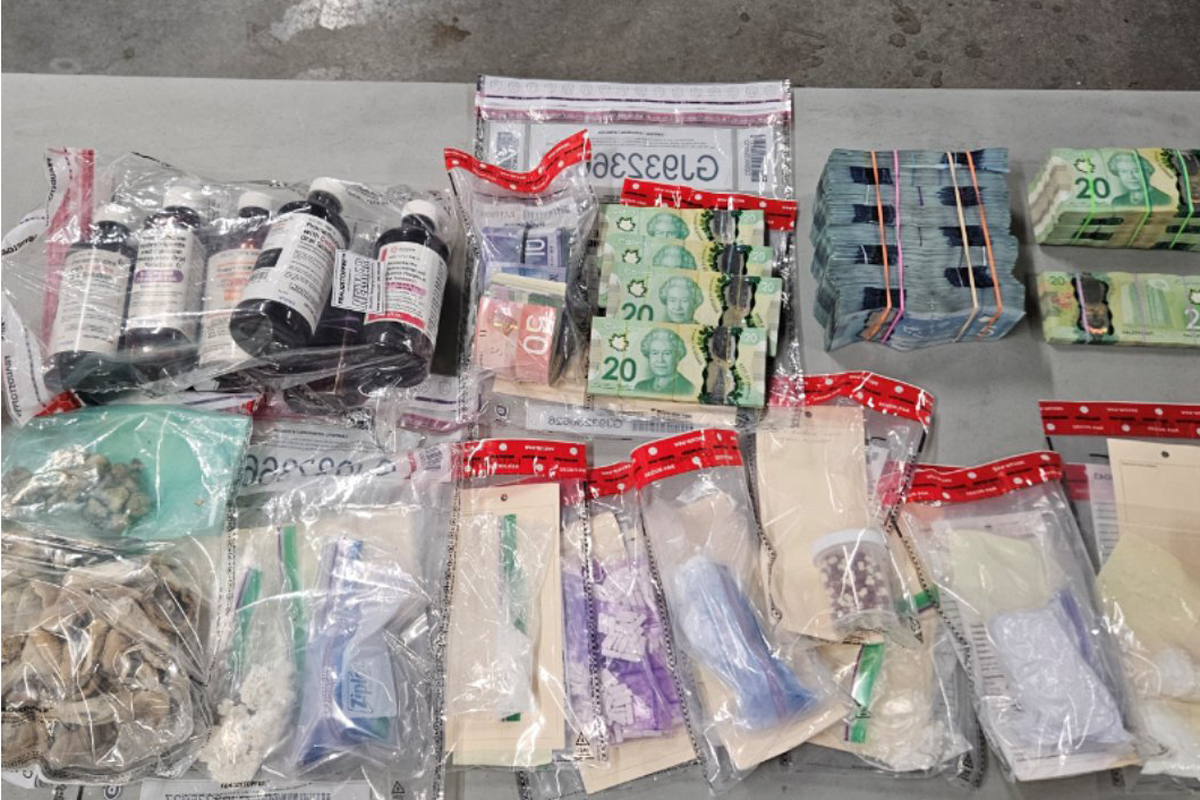 In addition to the guns and drugs, police say officers also seized a taser, cash and ammunition.