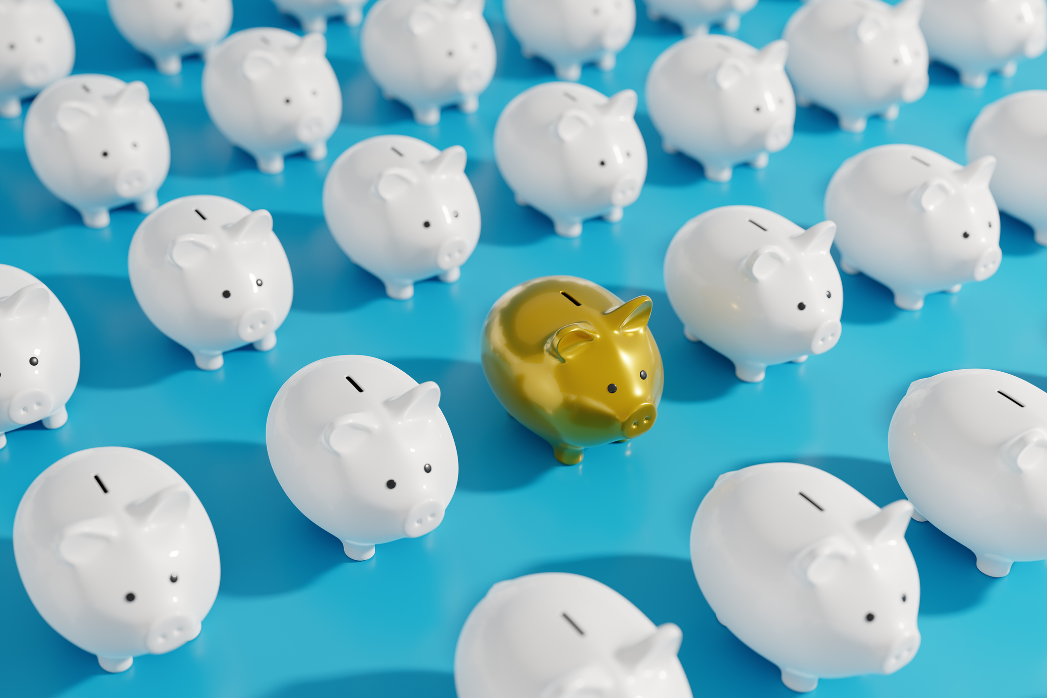 line of piggy banks, one gold