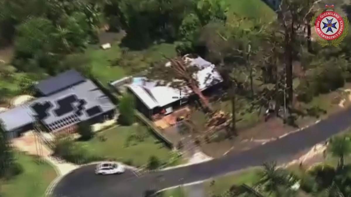 A fallen tree is pictured on the roof of a home in the southeast Queensland region of Australia on Dec. 26, 2023, after wild weather moved through the region.