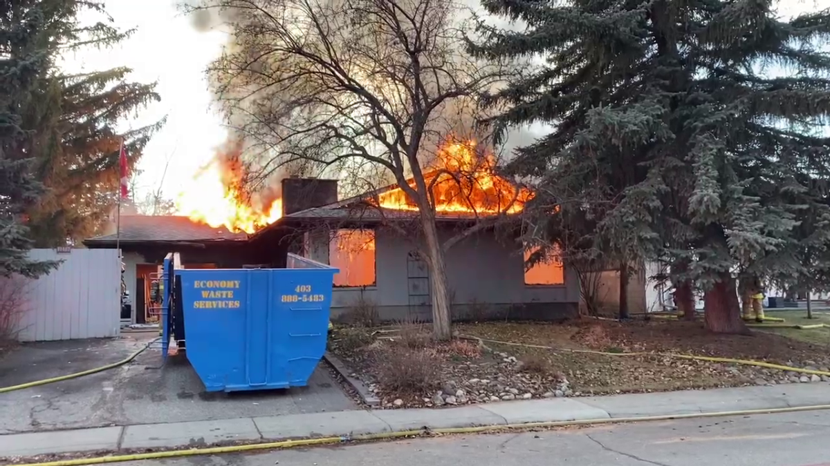 Calgary fire crews battled a fully engulfed house on fire in the southeast neighbourhood of Maple Ridge on Tuesday.