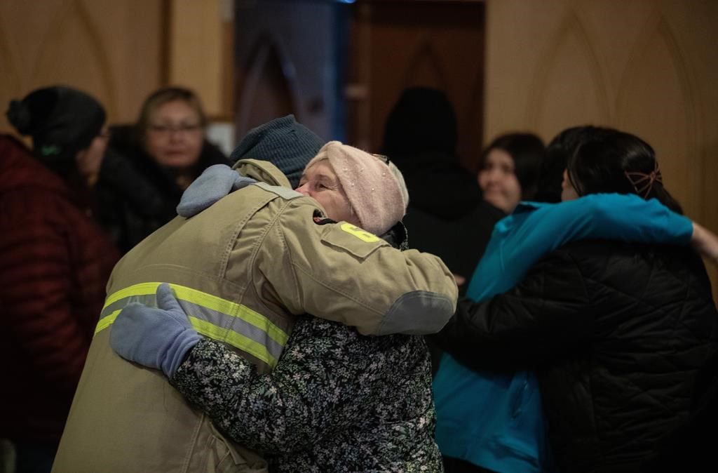 Community members gather and hold a vigil for the six people killed in a plane crash, in Fort Smith, Northwest Territories, on Wednesday, January 24, 2024.THE CANADIAN PRESS/Jason Franson