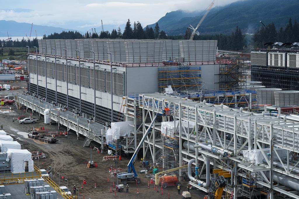 Cooling towers used to dissipate heat generated when natural gas is converted into liquefied natural gas are seen under construction at the LNG Canada export terminal, in Kitimat, B.C., on Wednesday, September 28, 2022. Canada's energy industry is reacting with dismay to U.S. president Joe Biden's move to pause approvals of new liquefied natural gas (LNG) export terminals in that country. THE CANADIAN PRESS/Darryl Dyck.