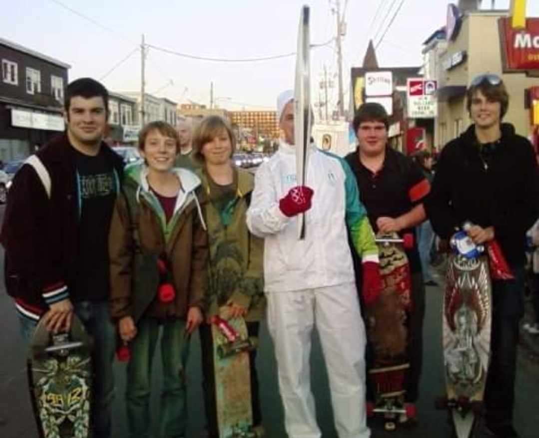 Backman and some friends pose alongside an Olympic torch bearer outside of the McDonald’s in 2010.