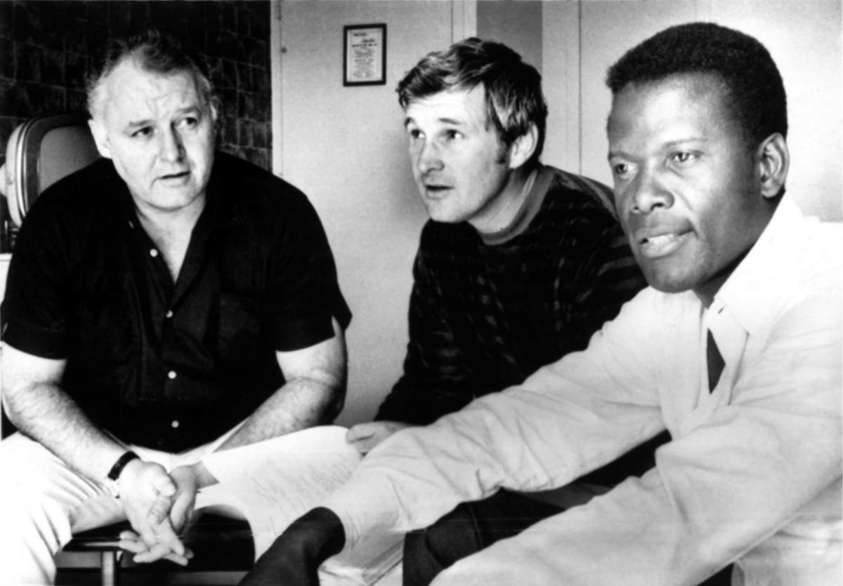 IN THE HEAT OF THE NIGHT, Rod Steiger, director, Norman Jewison, & Sidney Poitier, rehearsing the script, in Belleville, IL, September 23, 1966. Film was released in 1967.