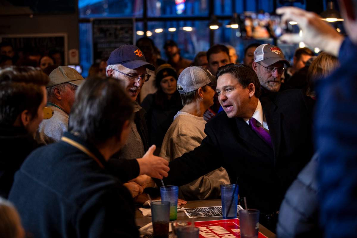 Republican presidential candidate Florida Gov. Ron DeSantis, right, greets supporters following a campaign event at Jerseys Pub and Grub in Cedar Rapids, Iowa, Monday, Jan. 15, 2024. (Nick Rohlman/The Gazette via AP)