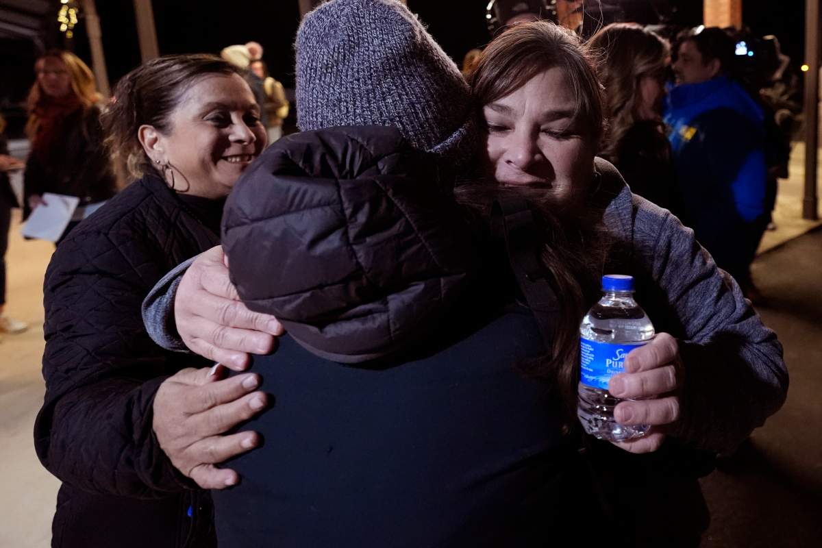 Dora Mendoza, left, and Berlinda Arreola, right, receive hugs as they leave a meeting where Attorney General Merrick Garland shared a report on the findings of an investigation into the 2022 school shooting at Robb Elementary School, Wednesday, Jan. 17, 2024, in Uvalde, Texas.