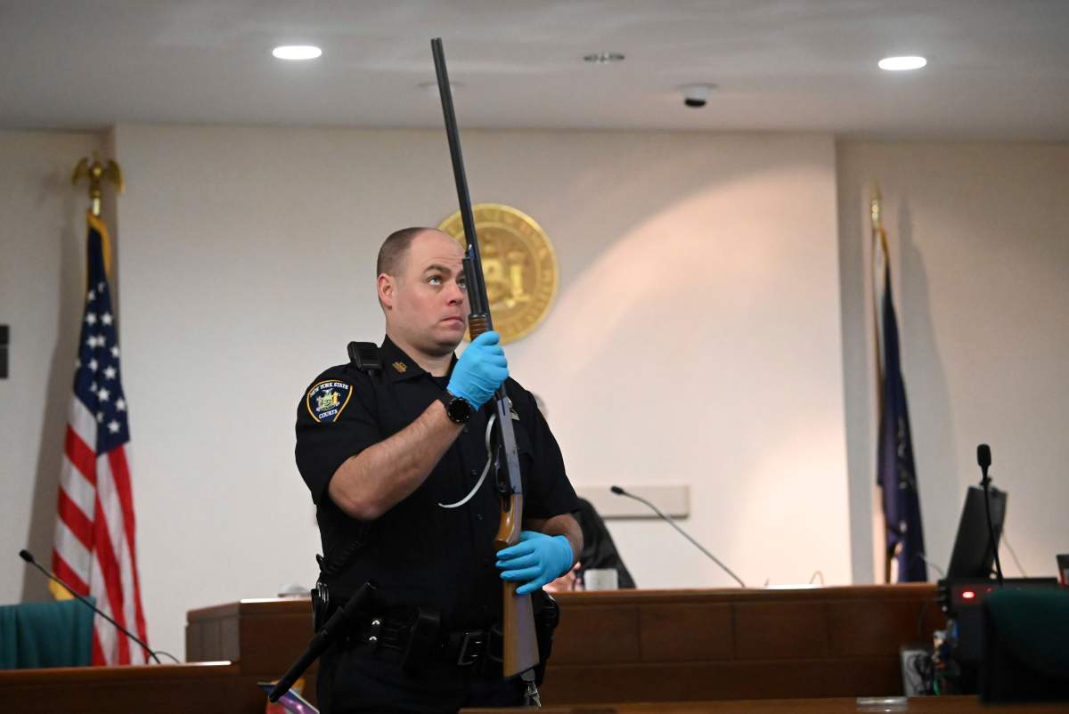 A NYS Court Police officer to holds Kevin Monahan's shotgun during summations in Monahan's murder trial, Tuesday, Jan. 23, 2024, at the Washington County Courthouse in Fort Edward, N.Y.