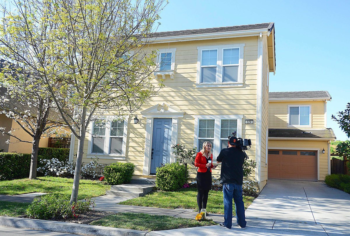 FILE - In this March 25, 2015 file photo, a news crew reports in front of the home of Denise Huskins.