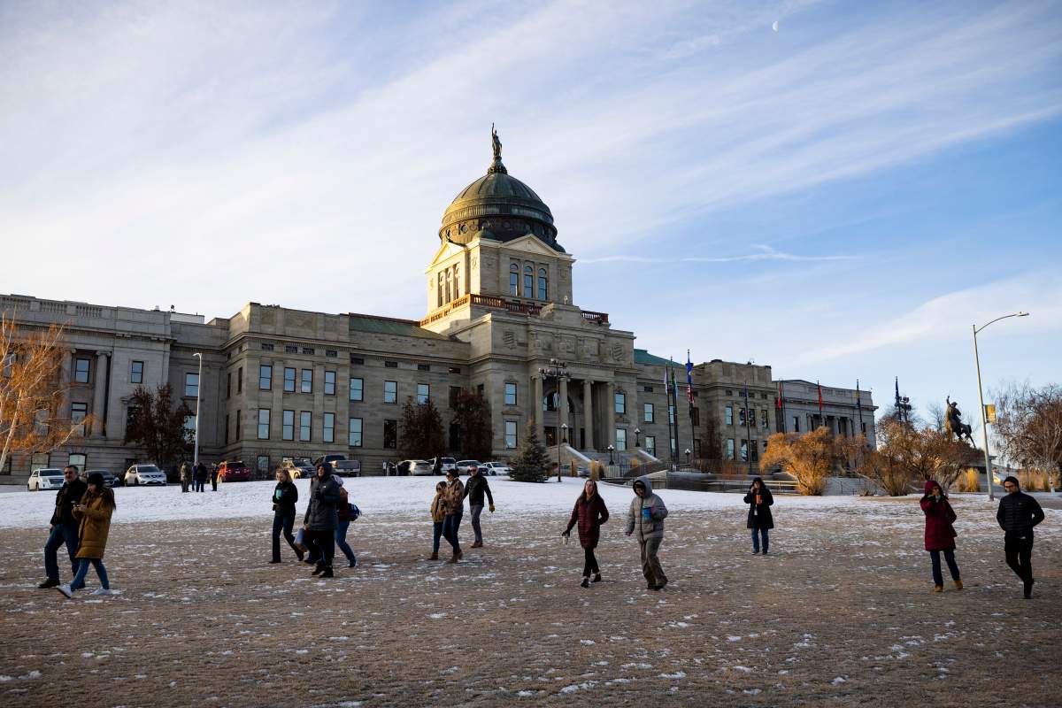 Staff evacuate from the Montana State Capitol, Wednesday morning, Jan. 3, 2023, after a bomb threat. (Thom Bridge/Independent Record via AP)