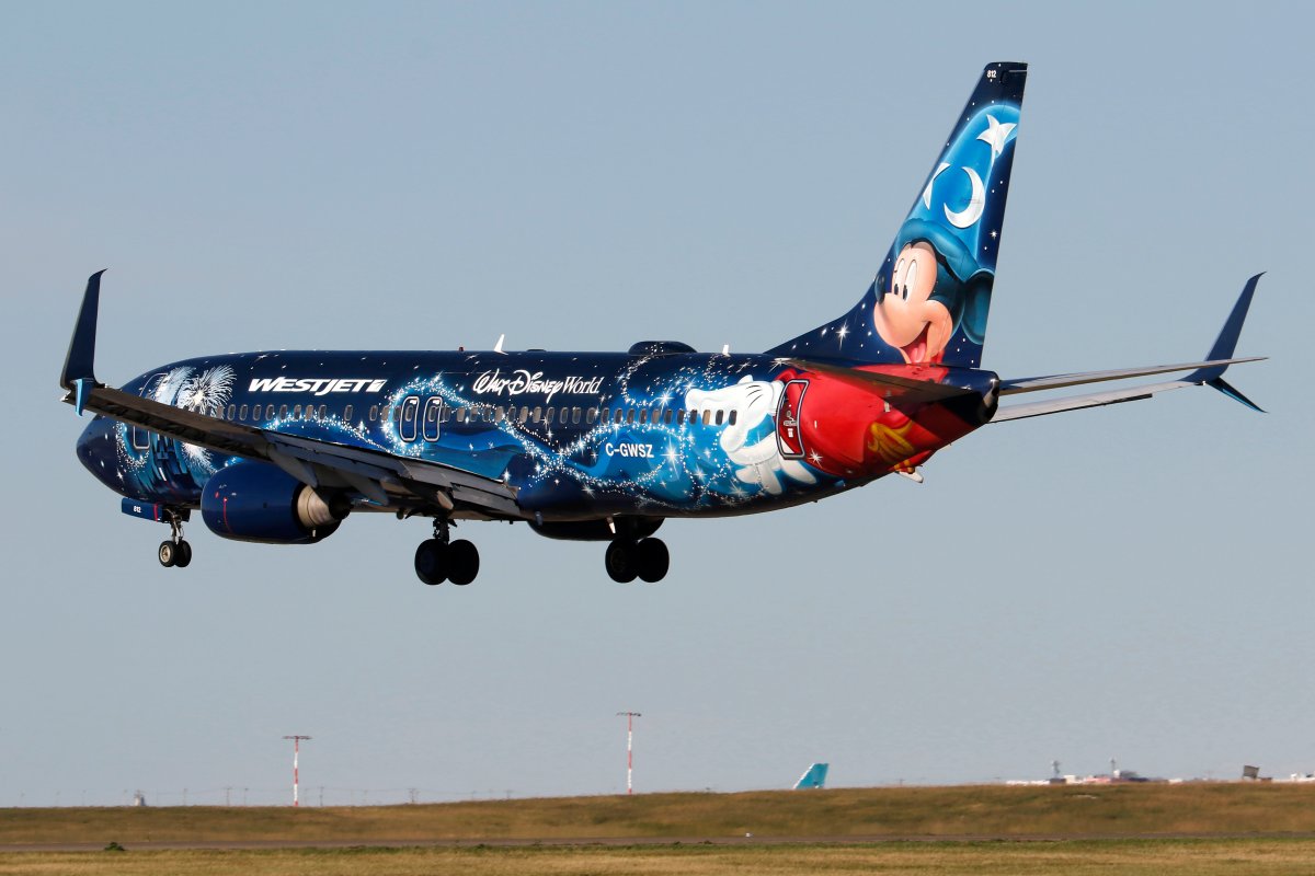 A Boeing 737 (737-800) jetliner belonging to WestJet Airlines and in Disney livery lands in Calgary, Alberta on Aug. 28, 2022. 