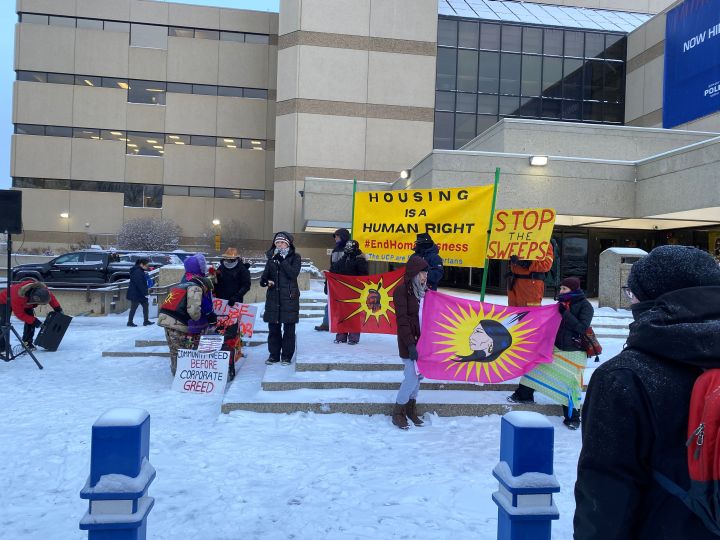 Protesters are seen outside the Edmonton Law Courts on Jan. 10, 2024 as a hearing was take place about the city's policies on encampments.
