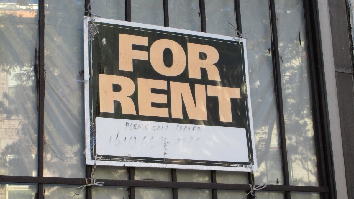 Photo of a 'For Rent' sign post on a door.