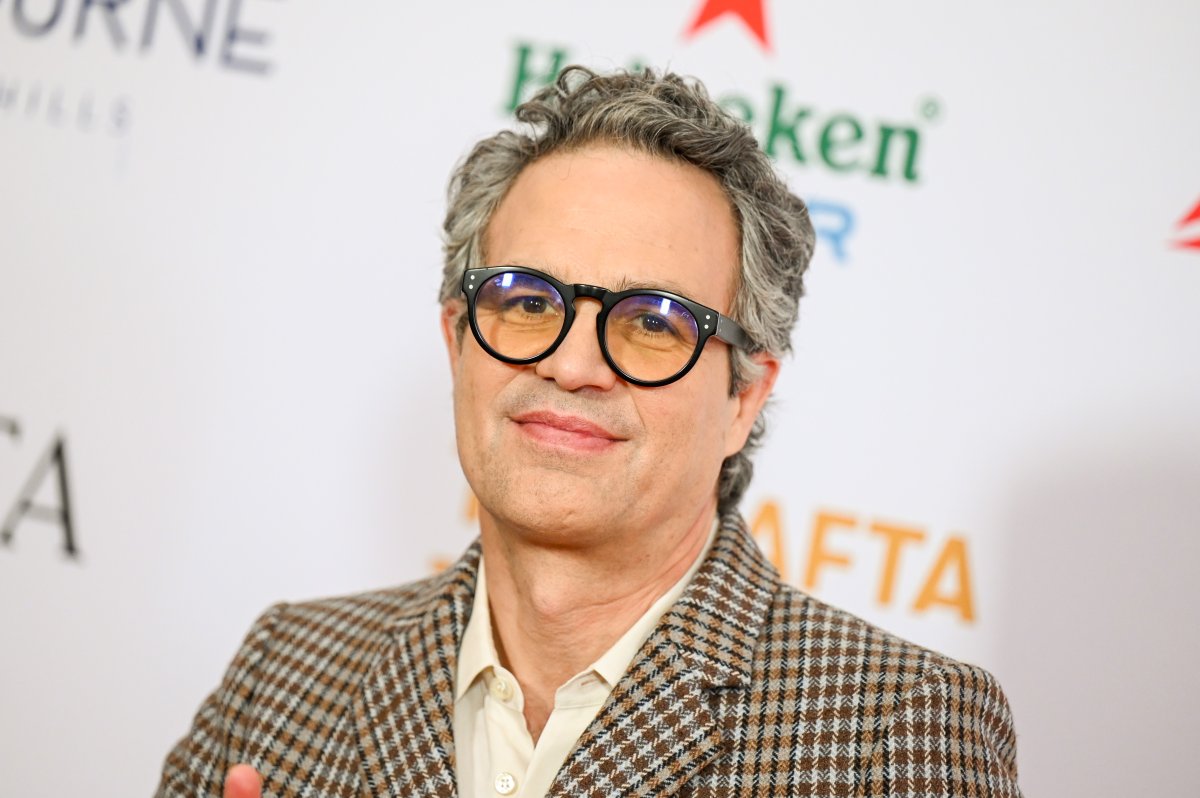 Mark Ruffalo in a tweed suit jacket and yellow-tinted sunglasses with a black rim.