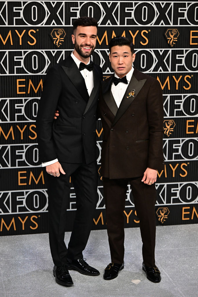 Actors Joel Kim Booster and John Michael Kelly arrive for the 75th Emmy Awards at the Peacock Theatre at L.A. Live in Los Angeles on January 15, 2024.