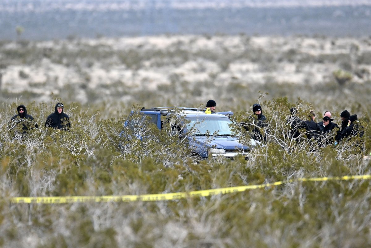 Investigators with the San Bernardino County Sheriff's Department investigate a scene where six bodies were discovered on a desolate high desert dirt road intersection off Highway 395 in El Mirage on Wednesday, Jan. 24, 2024.