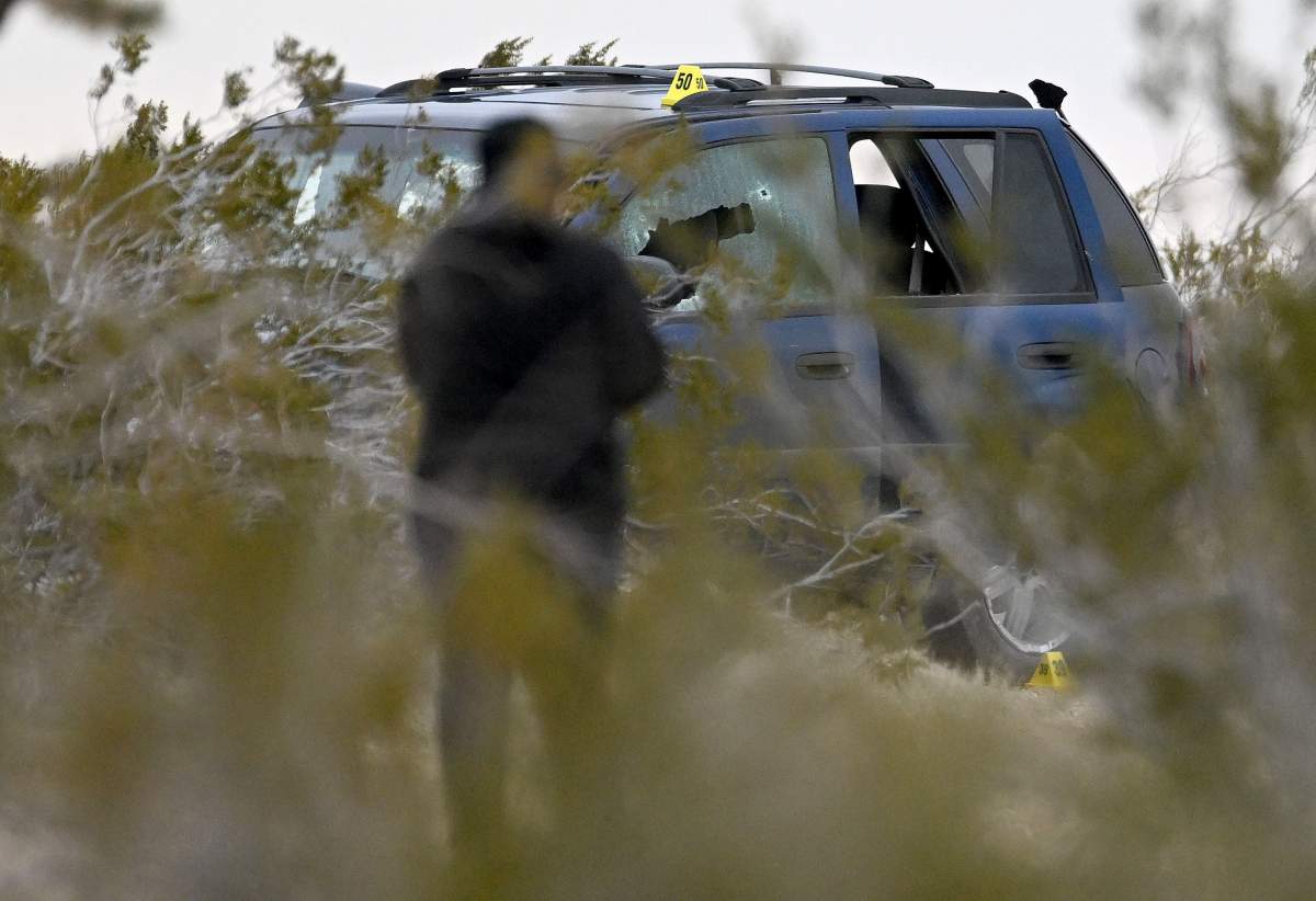 Bullet holes are seen in a vehicle as San Bernardino police investigate a scene where six bodies were discovered on a desolate high desert dirt road intersection off Highway 395 in El Mirage on Wednesday, Jan. 24, 2024.