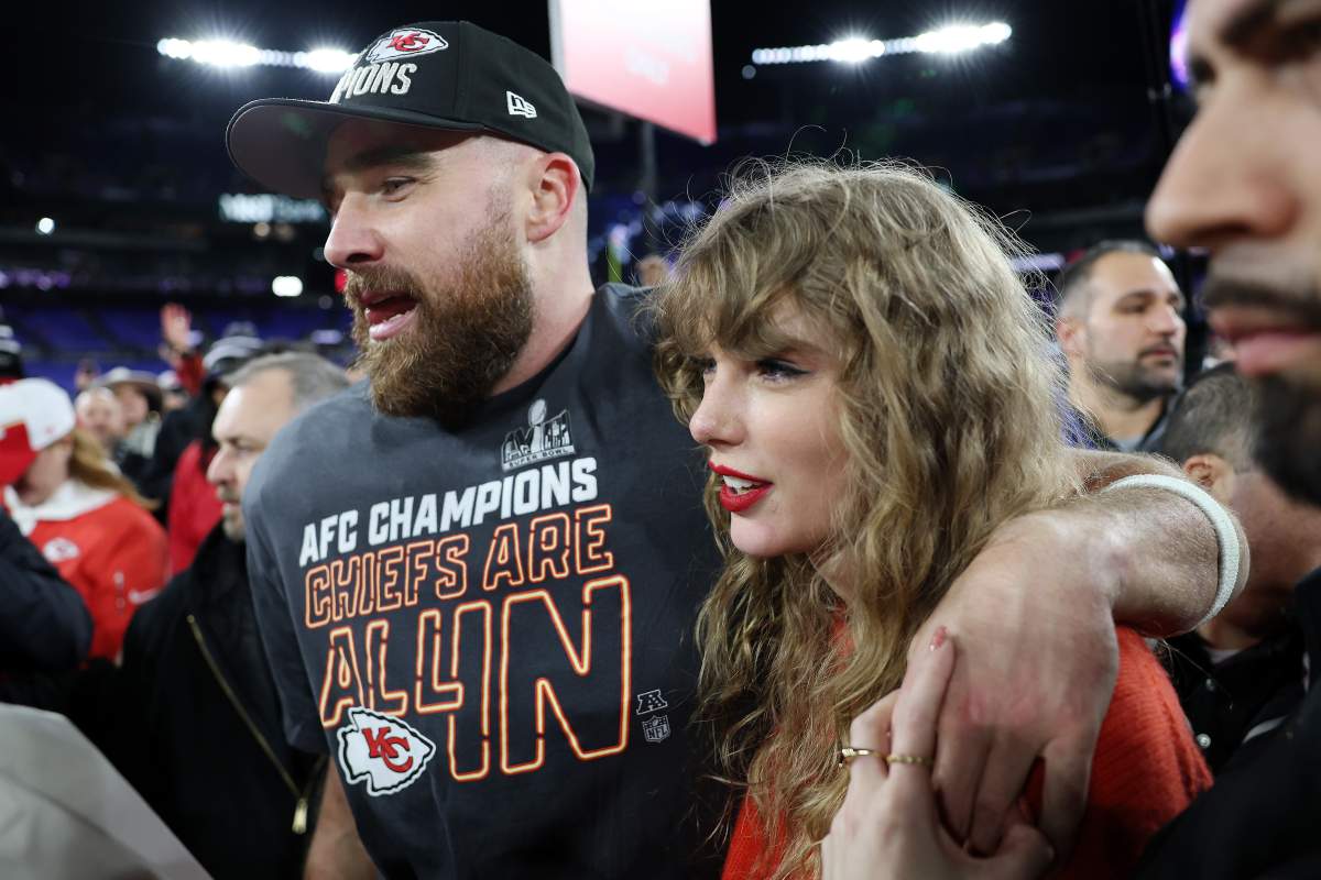 Travis Kelce #87 of the Kansas City Chiefs walks with his arm wrapped around Taylor Swift on the field after the Chiefs won the AFC Championship Game on January 28, 2024.