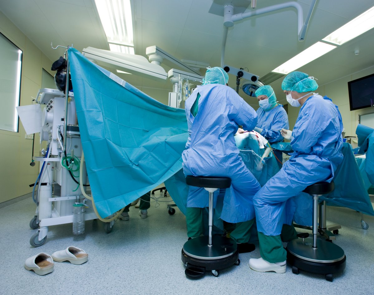 File photo of a team of surgeons operating to remove a brain tumour. A man in Florida was asked by his surgeons to play guitar during an awake craniotomy to remove a brain tumour.