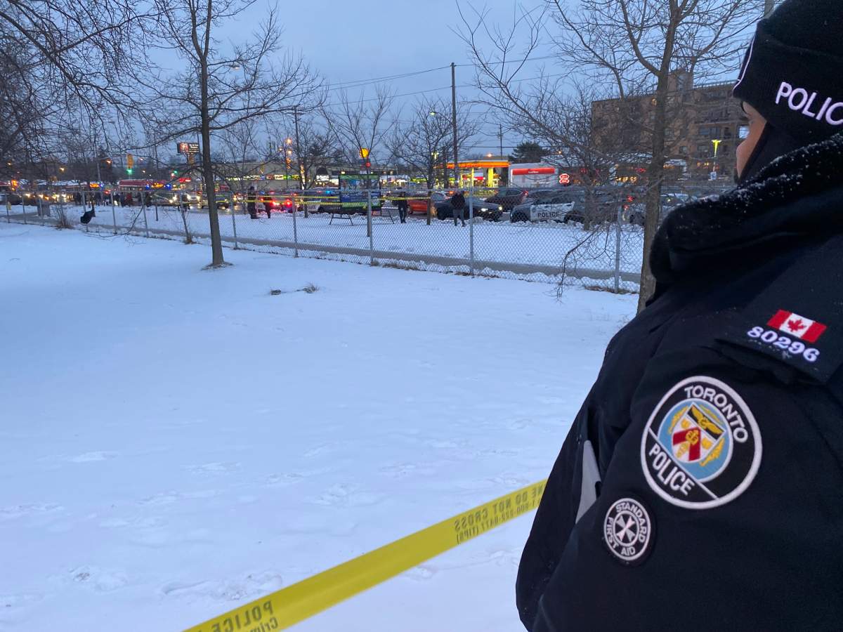 A police officer stands beside the scene of a stabbing in Toronto's Finch and Bathurst area. A 17-year-old boy faces charges, including assault with a weapon and aggravated assault.