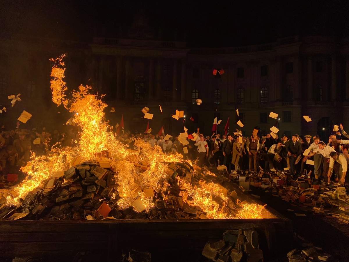 Still of a book burning in Nazi-era Germany depicted in 'Origin.'