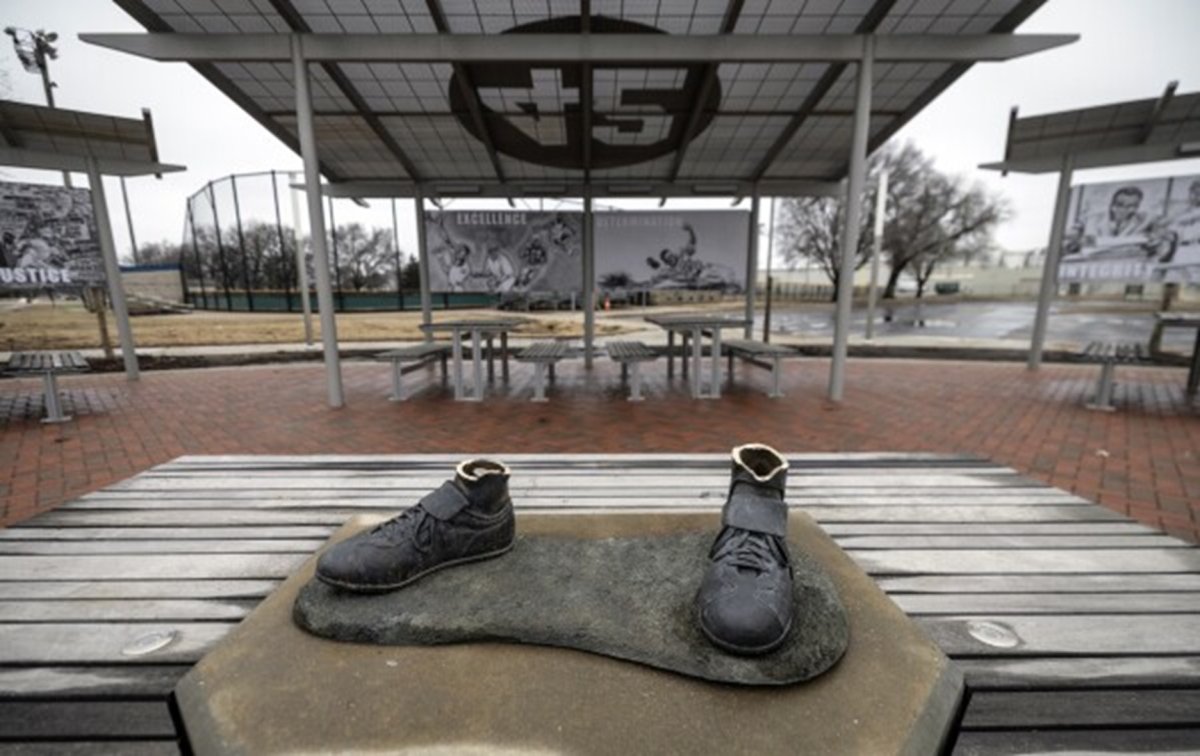 Bronze baseball shoes on a podium. The statue has been severed.
