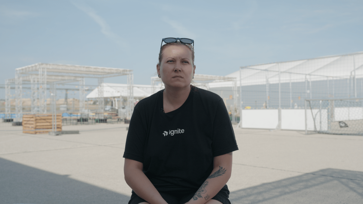 Kateryna sits outside of the Tegel Airport refugee camp in September 2023.