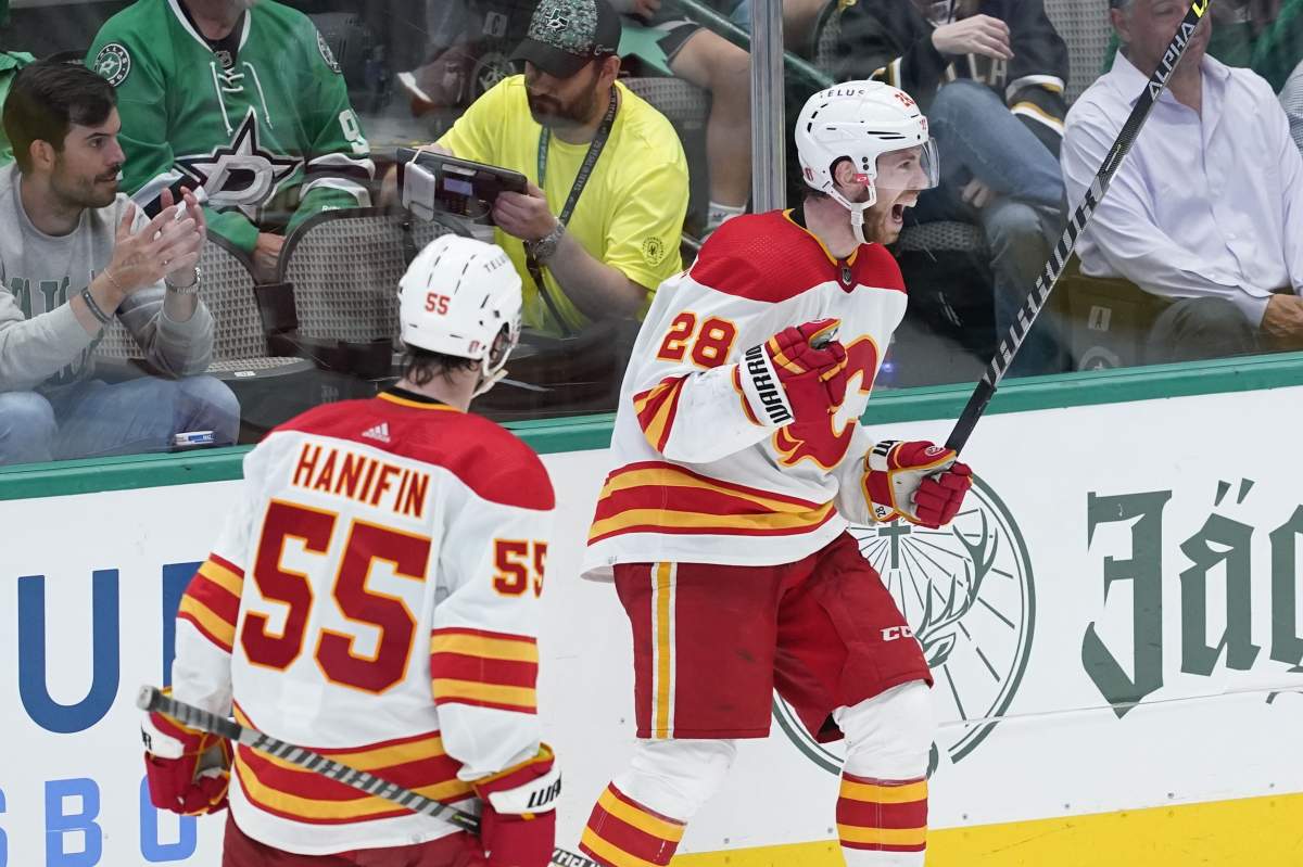 Calgary Flames centre Elias Lindholm (28) celebrates his goal with teammate Noah Hanifin (55) in the third period of Game 4 of an NHL hockey Stanley Cup first-round playoff series against the Dallas Stars, Monday, May 9, 2022, in Dallas.